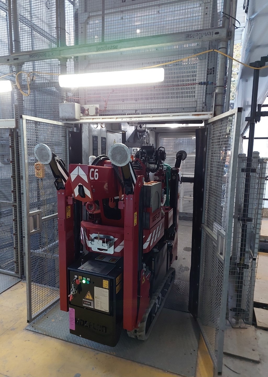 Compact Minicrane Hires Hoeflon c6 Crane is small enough to fit in construction site external lift.