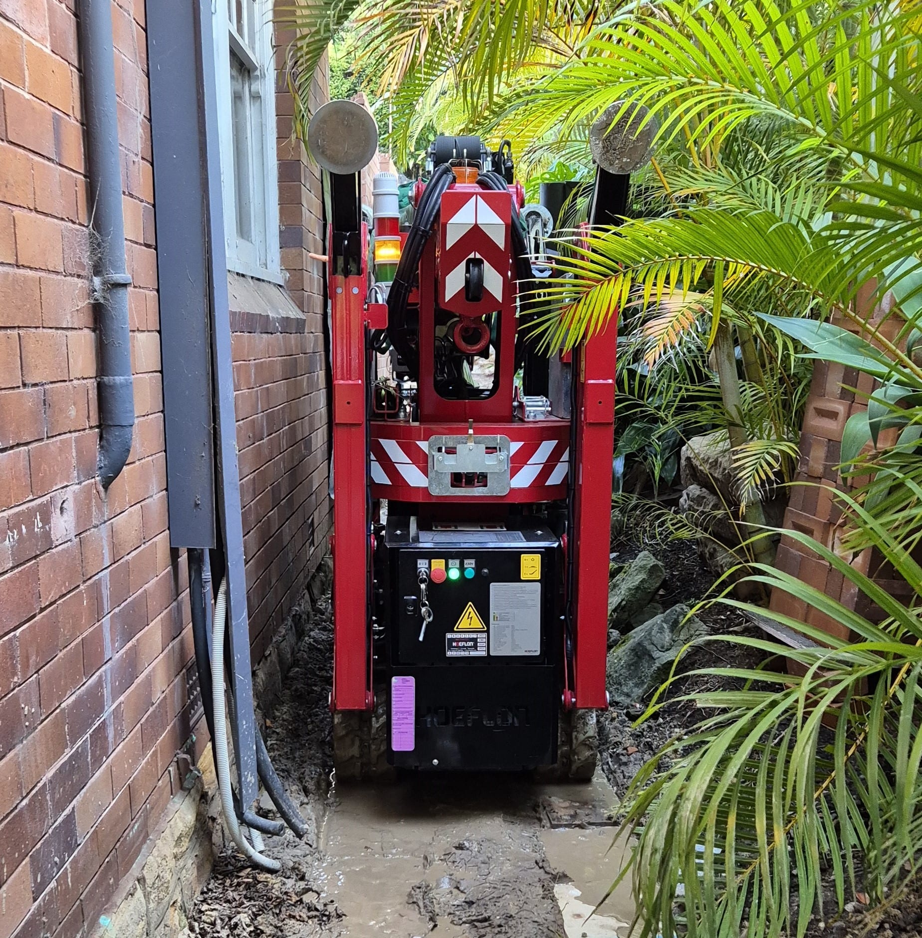 Tracking the crane down a tight side access of a residential property in Sydney.