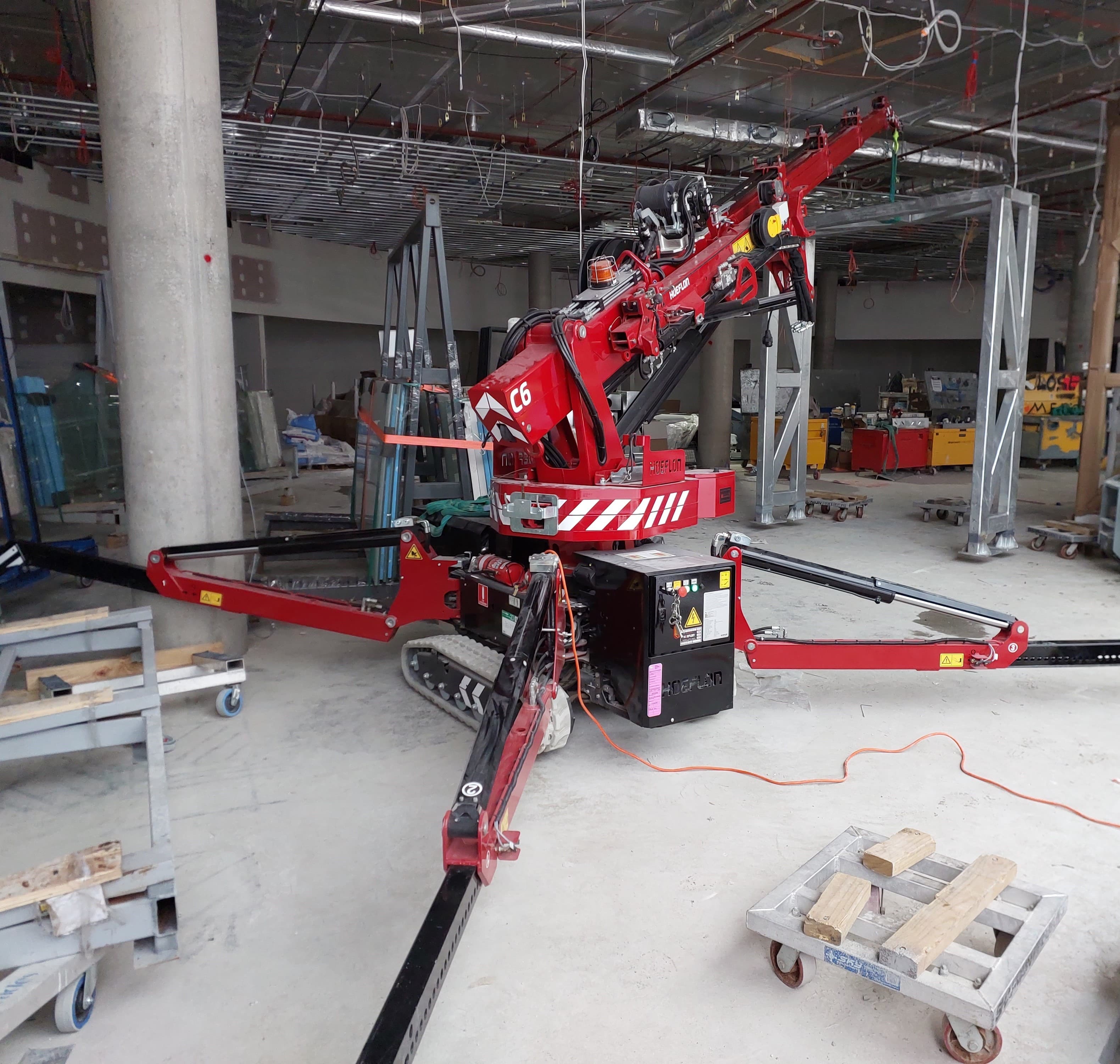 Compact Minicrane Hires Hoeflon c6 operating in the basement with low head room.