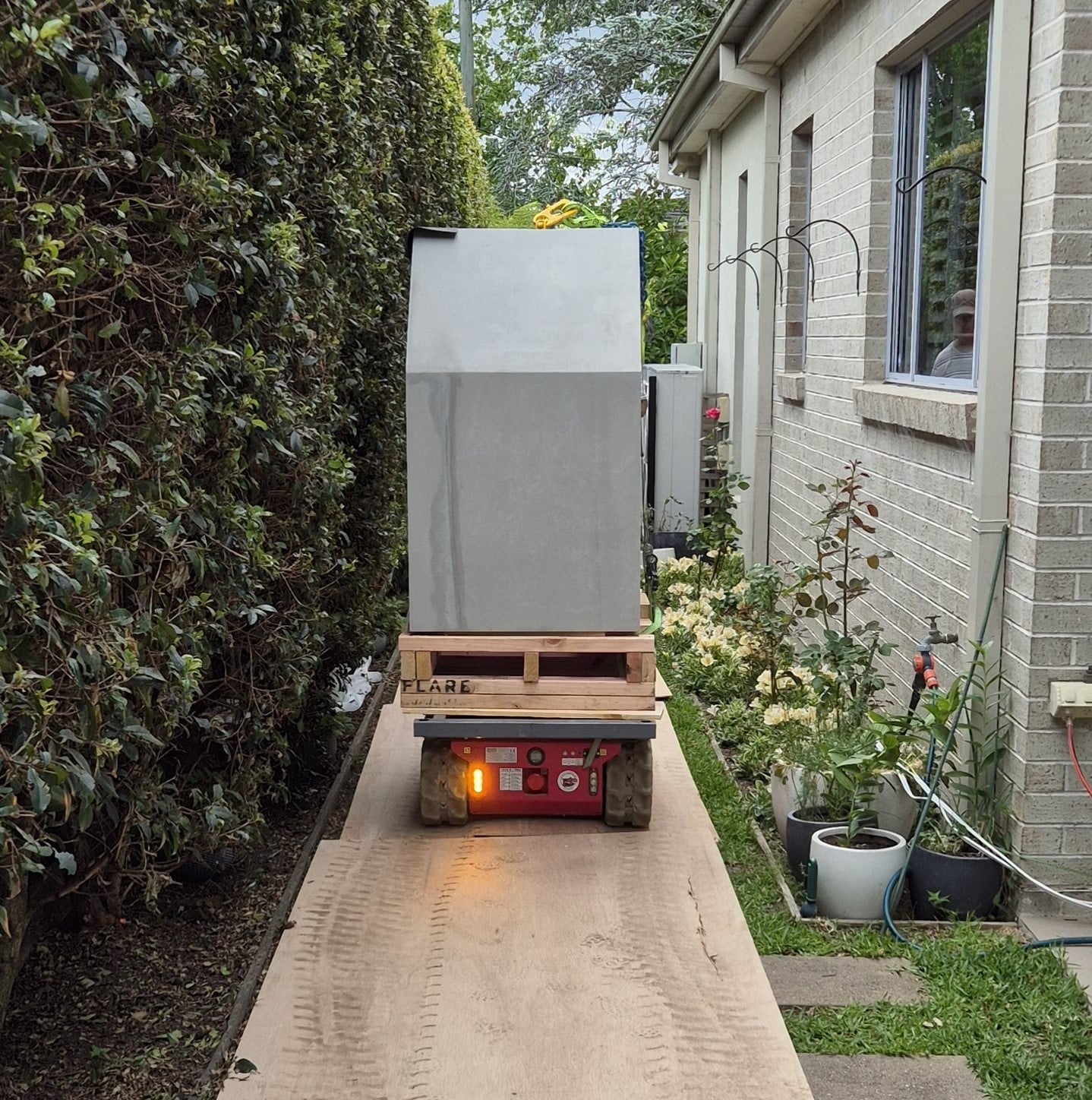 Transporting a modular fireplace on the tracked carrier weighing 1.2 tonne to be installed by the crane on the other end.