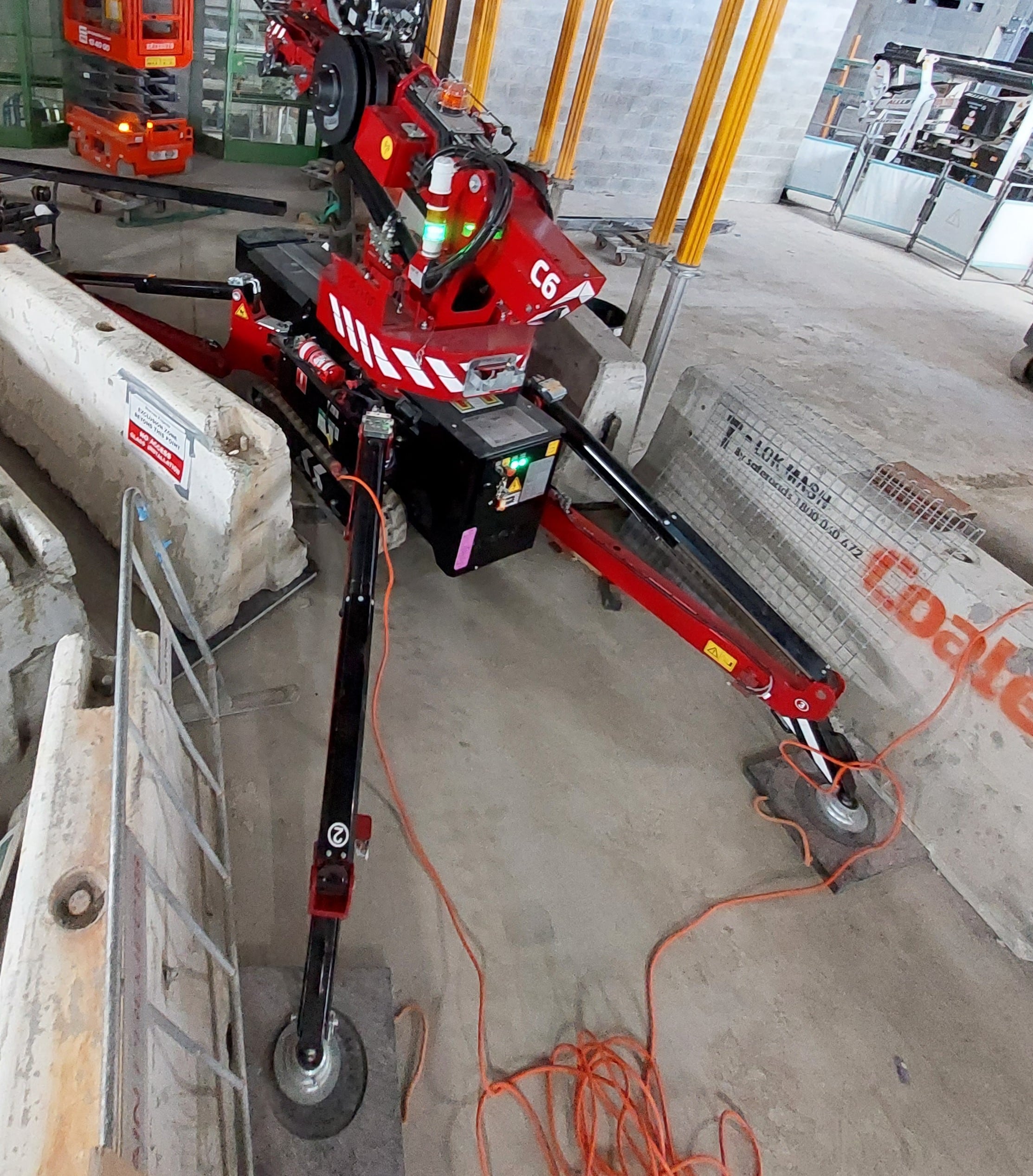 Hoeflon c6 crane setup between concrete barriers.