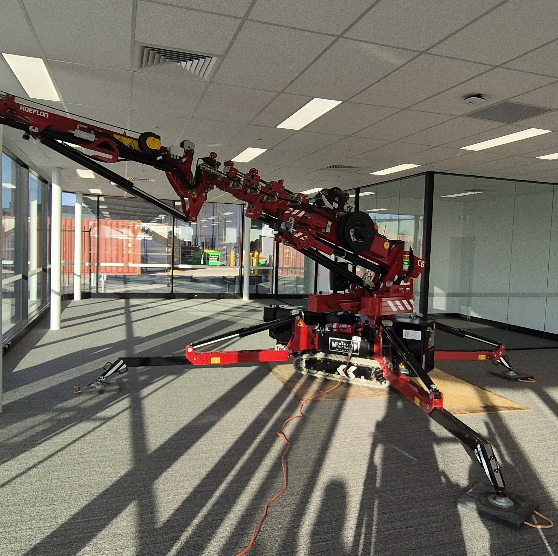 Hoeflon c6 Crane operating indoors using 10 amp electric power supply, eliminating noise and diesel fumes and emmisions.